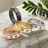 Anillo Giratorio para Reducir el Estrés – Acero Inoxidable con Patas Arcoíris